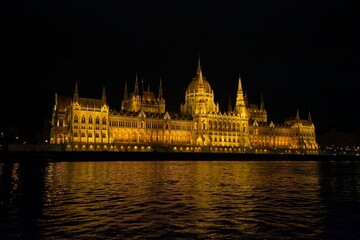 Fototapeta premium Hungarian Parliament Building illuminated at night with reflection on the Danube River, Budapest, Hungary