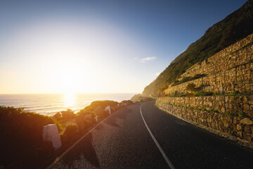 Scenic road along Ocean and Mountains at sunset. Chapman’s Peak Drive.
