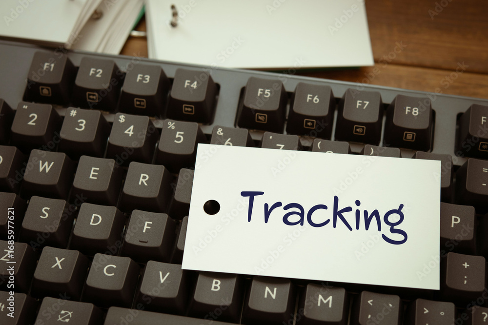 Poster there is notebook with the word tracking. it is as an eye-catching image.