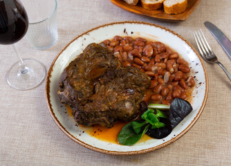 Gourmet dish - pork tenderloin fried to golden crust with side dish of tender and soft stewed beans...