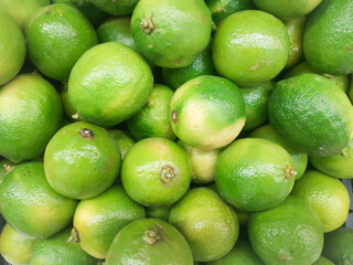 bright, juicy background with green lime fruits close-up.