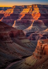 Stunning sunset light illuminating the layered rock formations of the Grand Canyon at dusk