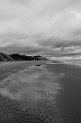 A beach with a cloudy sky in the background