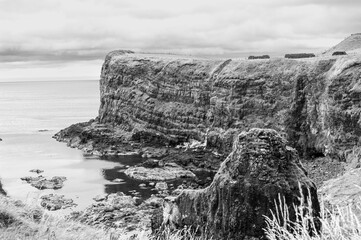 A rocky cliff overlooks the ocean