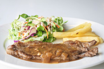 Grilled beef steak, boiled french fries and vegetable salad