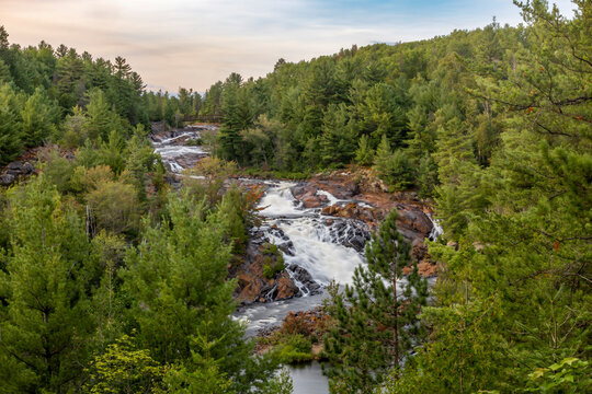 Onaping Falls near Sudbury, Ontario, showcases a stunning cascade surrounded by lush forest, offering tranquility in nature.