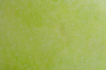 Green apple as a background macro photo.