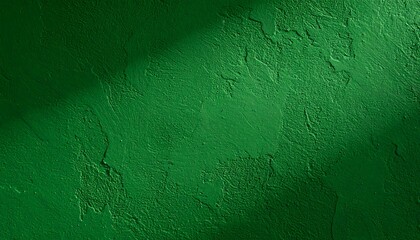 Textured emerald green wall with a diagonal shadow cutting across the top