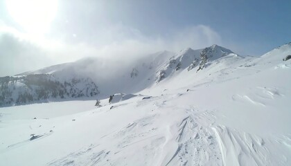 Snowy mountain landscape under bright sky
