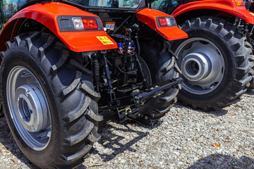 Rear view of modern agricultural tractor in hangar. Hydraulic hitch. Hydraulic lifting frame