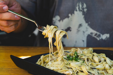 Italian fettuccine pasta with cream, chicken and mushrooms. Creamy chicken and mushroom fettuccine...