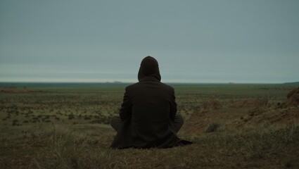 Silhouette of Person Meditating in Field at Dusk
