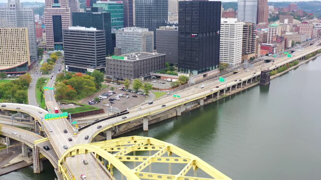Drone View of Downtown Pittsburgh, Pennsylvania, USA on March 23, 2023 Featuring the Iconic Fort Pitt Bridge, Skyscrapers, Rivers, and Urban Traffic During Sunset