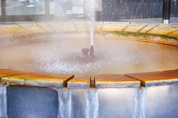Geothermal spa fountain with mineral deposits and bubbling water, geyser