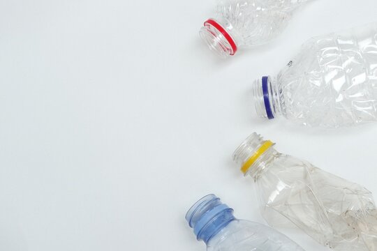 Group of plastic bottle waste with negative space on white background