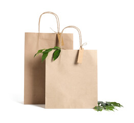 Eco friendly packaging. Paper bags and leaves isolated on white