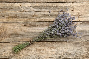 Bunch of aromatic lavender flowers on wooden table, top view