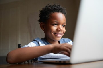 Smiling Young Boy Using Laptop at Home - Educational Technology