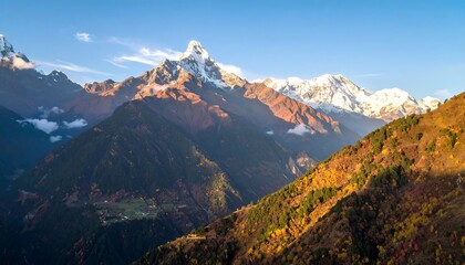 Naklejka premium A breathtaking vista of snow-capped mountain peaks, vibrant autumn foliage, and a serene valley nestled amongst rugged mountain ranges.