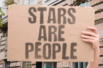 “Stars Are People” appears on a protest banner, demanding equality and recognition of human...