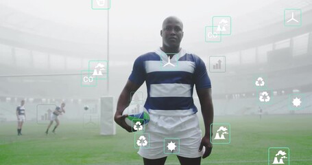 Lead rugby player walking onto misty pitch and initiating analytics icons drifting for analysis - Powered by Adobe