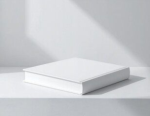 White book mockup on a white surface with sunbeams