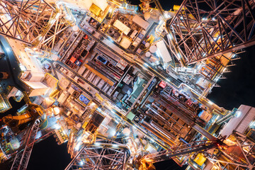Obraz premium Aerial top view of offshore jack up rig and offshore platform during sunset for oil and gas exploration and production.
