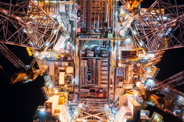 Aerial top view of offshore jack up rig and offshore platform during sunset for oil and gas...