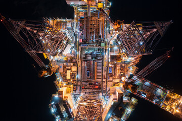 Aerial top view of offshore jack up rig and offshore platform during sunset for oil and gas...