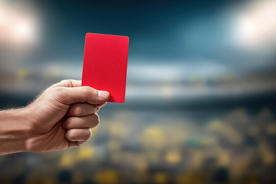 Referee showing a red card during an exciting soccer match at a stadium