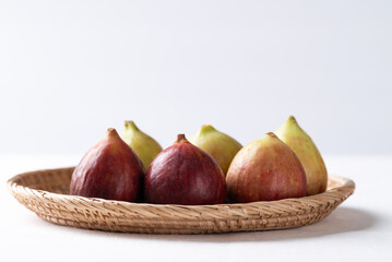 Fresh fig in basket on white background, Autumn fruit
