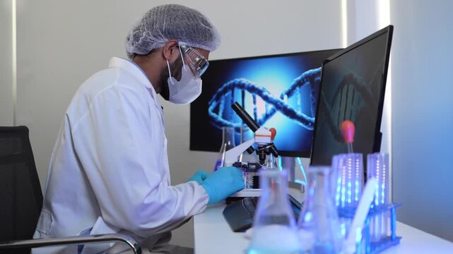 A geneticist performs microscopic analysis of a cellular sample, cross-referencing observations with genomic data displayed on a bioinformatics workstation in a biotech lab.