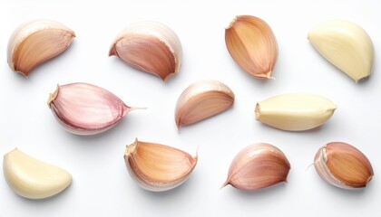 A collection of garlic cloves in various colors and textures arranged on a white background, ideal for culinary and health-related themes.