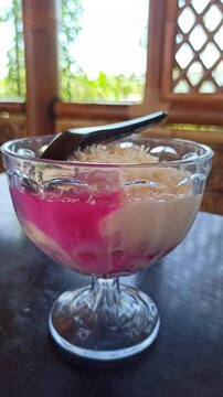 Es oyen with cheese topping, a refreshing Indonesian dessert with mixed fruits, shaved ice, sweet syrup, and creamy cheese for a unique taste.
