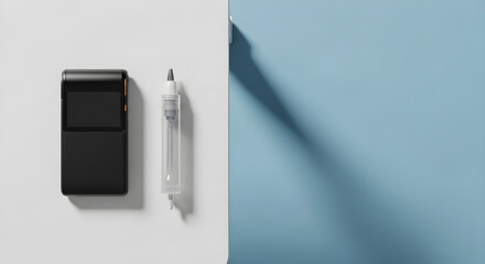 Black electronic device and clear liquid dispenser on contrasting white and blue backgrounds with shadow