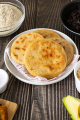 Homemade Venezuelan arepas filled with caraotas, avocado, cheese, and fried plantains