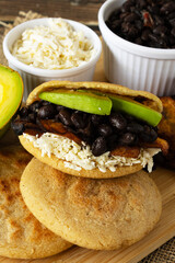 Authentic Venezuelan arepas with black beans, fried plantains, avocado, and cheese