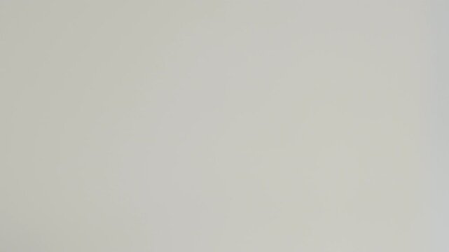 A medical syringe with saline solution dripping from the needle against a plain white background