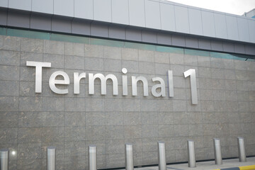 Signage for terminal one at an airport location