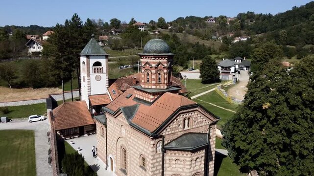 Aerial view of Church of Saint Basil of Ostrog near Valjevo, Serbia, surrounded by rural landscape. g.