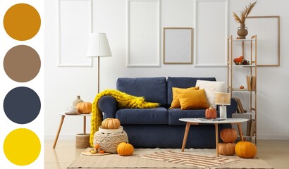 Interior of living room with blue sofa, shelf unit and pumpkins. Different color patterns