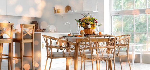 Pumpkin with autumn bouquet on dining table in kitchen