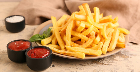 Plate with french fries and bowls of ketchup on table, closeup