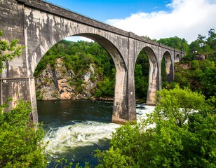 Fototapeta premium Stone arch bridge over a river
