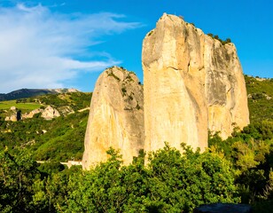 Two towering sandstone peaks amidst a lush valley