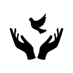 Dove releasing from hands symbolizes peace and freedom in black silhouette