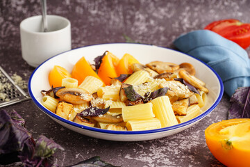Plate with delicious Italian pasta salad on grunge background