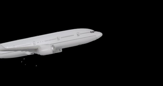 White model passenger jet in flight left to right and isolated with alpha channel for use with aerospace, aviation, travel, technology, and business concepts