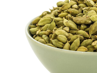 Bowl with cardamom spice on white background, closeup