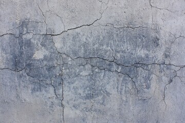 Cracked, textured surface; pale grey tones